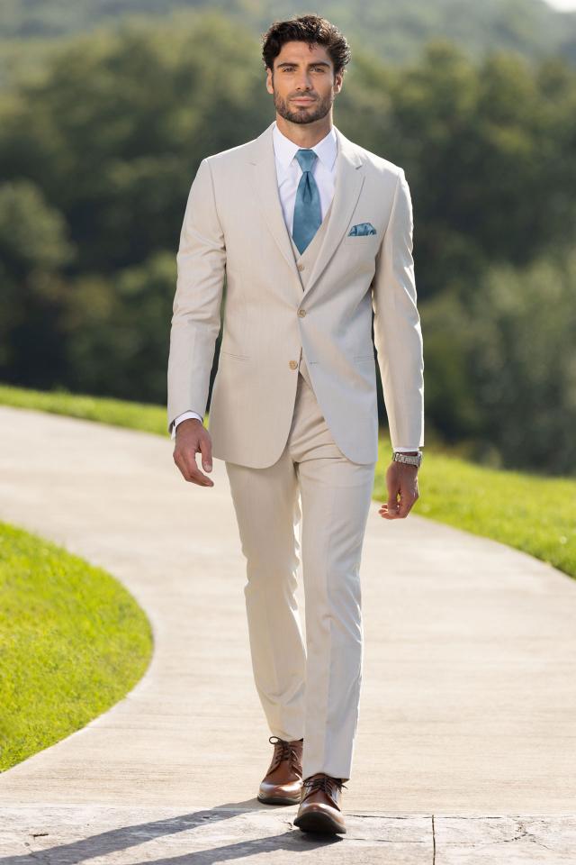 man wearing Michael Kors Tan Performance Stretch Suit with matching vest and teal windsor tie